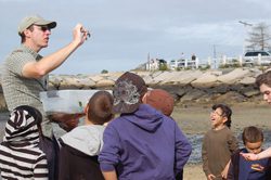 Jesse Mechling Director for Education, shares the secret wonders of Provincetown's tidal flats with a group of enthusiastic young naturalists. PCCS image.
